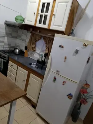 a kitchen with a refrigerator with magnets on it at Cabañas La Enriqueta in Villa Carlos Paz