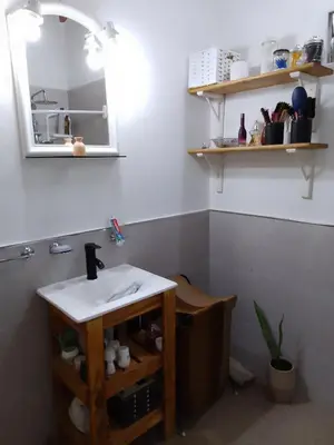 a bathroom with a sink and a mirror at Cabañas La Enriqueta in Villa Carlos Paz