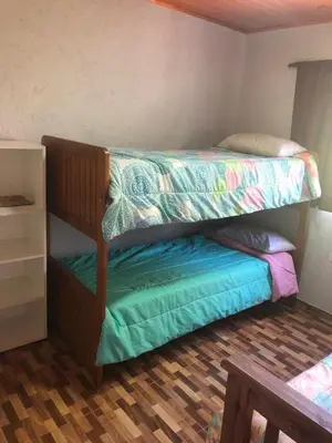 a bedroom with two bunk beds in a room at Genesis Paz y Montaña Mallin Tanti in Tanti