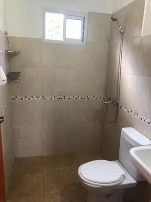 a bathroom with a shower and a toilet and a sink at Genesis Paz y Montaña Mallin Tanti in Tanti
