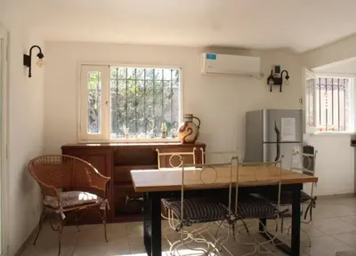 a room with a table and chairs and a piano at Reina Paz in Cordoba