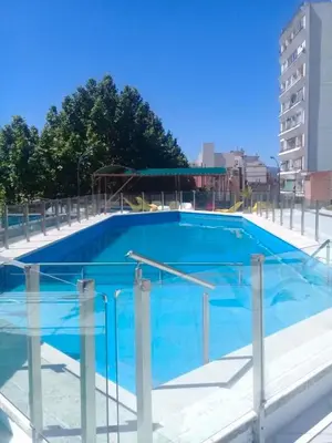 a large blue swimming pool in a city at Departamento Acuario II - a metros del shopping woo in Villa Carlos Paz