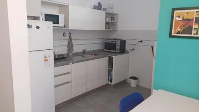 a small kitchen with a refrigerator and a microwave at Cañada in Cordoba