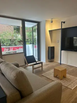 a living room with a couch and a tv at Departamento Blue - Piso 1 Laprida Once in Cordoba