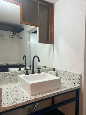 a bathroom counter with a white sink and a mirror at Departamento Blue - Piso 1 Laprida Once in Cordoba