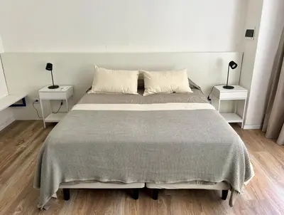 a bedroom with a large bed with two night stands at Departamento Blue - Piso 1 Laprida Once in Cordoba