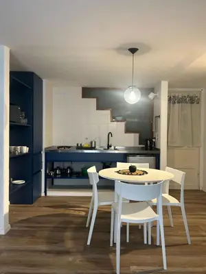 a kitchen with a white table and white chairs at Departamento Blue - Piso 1 Laprida Once in Cordoba