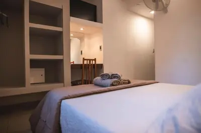 a bedroom with a bed with two towels on it at Hotel Carlos Paz Centro - MONTECATINI in Villa Carlos Paz
