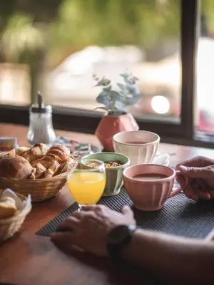 a table with breakfast foods and a glass of orange juice at Hotel Carlos Paz Centro - MONTECATINI in Villa Carlos Paz