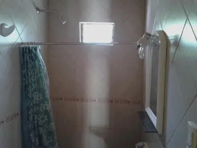 a bathroom with a shower curtain and a window at Cabaña NANO in Tanti