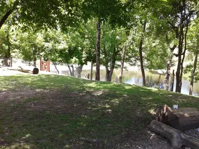 a park with trees and a body of water at Cabaña NANO in Tanti