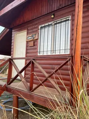 a wooden cabin with a window on the side of it at Kapo TEAM , colibri in Villa Amancay
