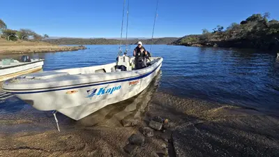 a man is standing on a boat in the water at Kapo TEAM , colibri in Villa Amancay