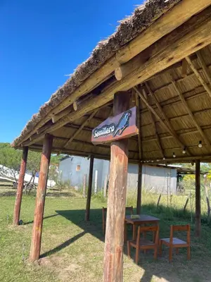 a wooden pavilion with a sign on top of it at Kapo TEAM , colibri in Villa Amancay