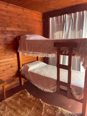 two bunk beds in a cabin with a window at Kapo TEAM , colibri in Villa Amancay