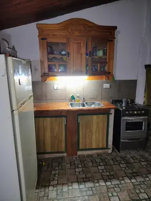 a kitchen with a sink and a stove at Refugio del Rio in Los Reartes
