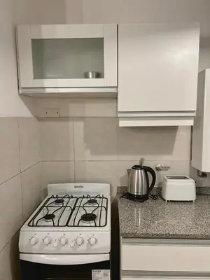 a white stove top oven in a kitchen at Independencia Housing in Cordoba