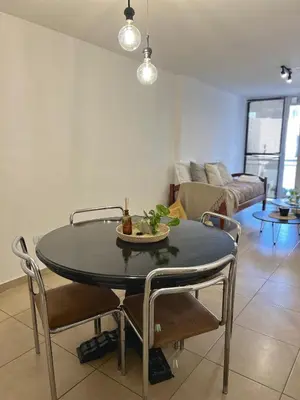 a dining room table and chairs in a living room at Independencia Housing in Cordoba