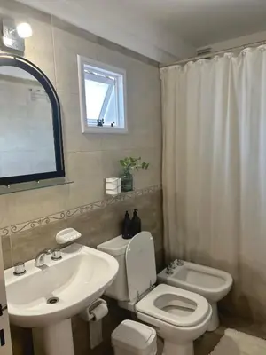 a bathroom with a white toilet and a sink at Independencia Housing in Cordoba