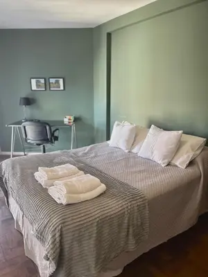 a bedroom with a bed with two towels on it at Independencia Housing in Cordoba