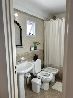 a bathroom with a white toilet and a sink at Independencia Housing in Cordoba
