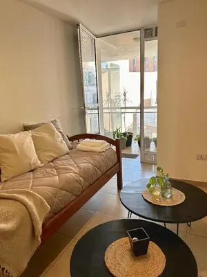 a living room with a couch and two tables at Independencia Housing in Cordoba