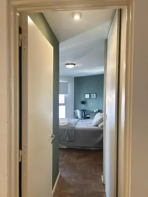 a room with a bed and a bedroom with blue walls at Independencia Housing in Cordoba