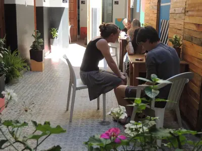 a woman sitting at a table with a man at 531 Hostel in Cordoba