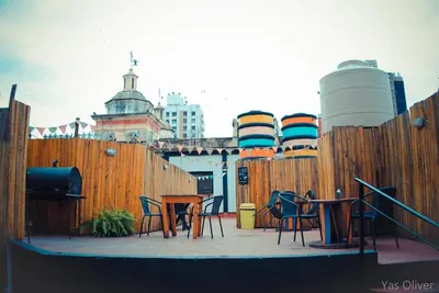 a wooden fence with chairs and tables on a patio at 531 Hostel in Cordoba