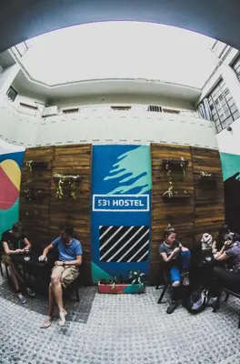 a group of people sitting in front of a stage at 531 Hostel in Cordoba