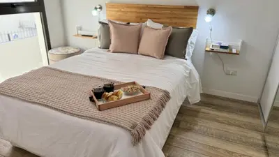 a bed with a tray of donuts on it at Eloise II, excelente ubicación y con todo lo que necesitas! in Villa Carlos Paz