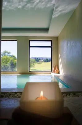 a room with a candle in front of a swimming pool at Ayres del Champaqui Hotel Boutique Experiencial & Spa in Villa General Belgrano