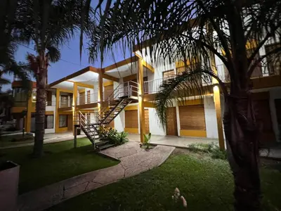 a building with a staircase in front of it at Cybeles Family Apart in Villa Carlos Paz