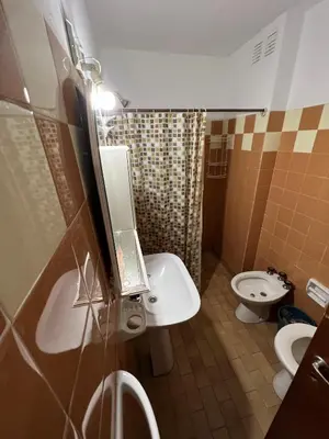 a bathroom with a sink and a toilet and a mirror at Cybeles Family Apart in Villa Carlos Paz
