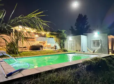 a swimming pool in a yard at night at Mauro y Sonia in Estancia Vieja