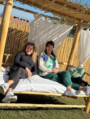 two girls sitting on a bed in a gazebo at Mauro y Sonia in Estancia Vieja