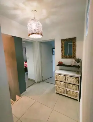 a hallway with a mirror and a chandelier at Mauro y Sonia in Estancia Vieja