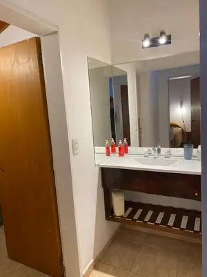 a bathroom with a sink and a large mirror at Piedras Moras in Villa General Belgrano