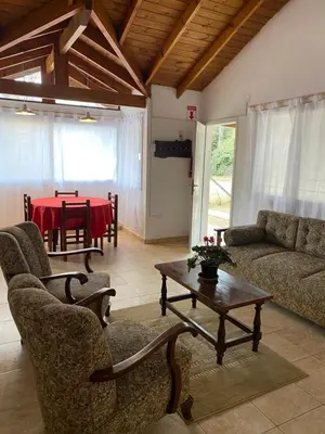 a living room with a couch and a table at Piedras Moras in Villa General Belgrano