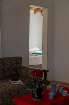 a living room with a couch and a table with flowers at Piedras Moras in Villa General Belgrano