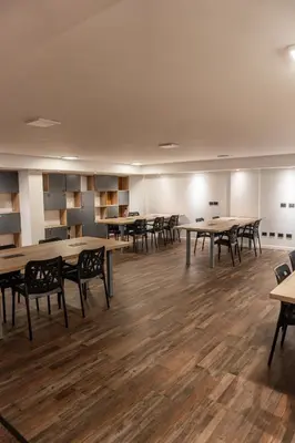 an empty room with tables and chairs in it at Departamento NYC 4 Premium - Edificio VILAUT by INMOVE Temporarios in Cordoba