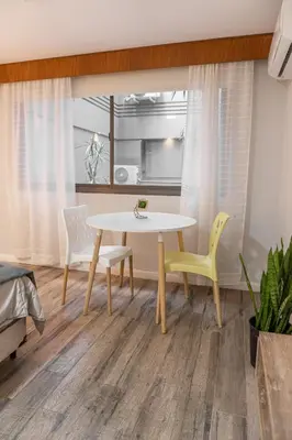 a dining room with a table and two chairs at Departamento NYC 4 Premium - Edificio VILAUT by INMOVE Temporarios in Cordoba