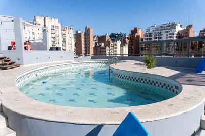 a large swimming pool on the roof of a building at Departamento NYC 4 Premium - Edificio VILAUT by INMOVE Temporarios in Cordoba