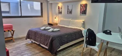 a bedroom with a bed with two pillows on it at Departamento 5 Londres - Edificio VILAUT by INMOVE Temporarios in Cordoba
