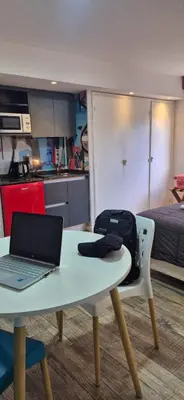 a kitchen with a table with a laptop on it at Departamento 5 Londres - Edificio VILAUT by INMOVE Temporarios in Cordoba