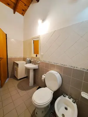 a bathroom with a toilet and a sink at Casa de campo in Los Hornillos