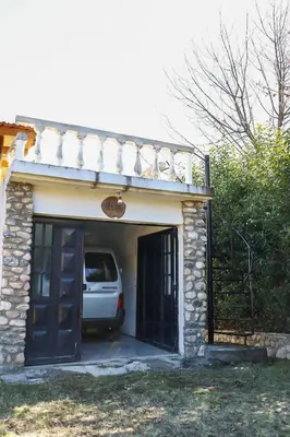 a white van is parked in a garage at Casa de campo in Los Hornillos