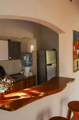 a kitchen with a counter top and a refrigerator at Casa de campo in Los Hornillos
