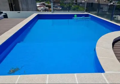 a blue swimming pool on top of a building at Carilo in Villa Carlos Paz