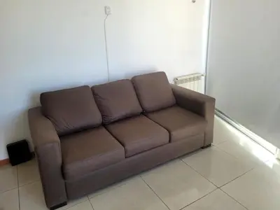 a brown couch sitting in a living room at Carilo in Villa Carlos Paz